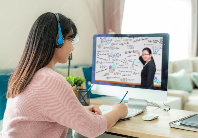 student attending an online tutoring class and taking notes