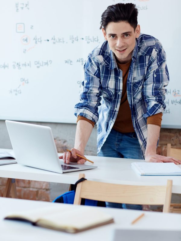 Creative designer standing by his workplace