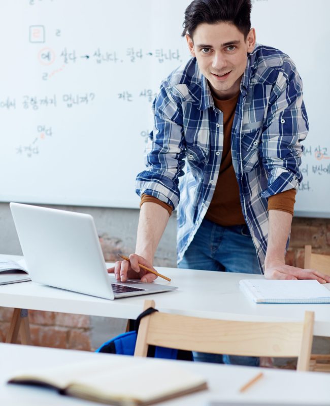 Creative designer standing by his workplace